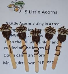 five little acorns sitting in a row on top of each other with chocolate icing