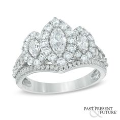 a white gold ring with three pear shaped diamonds on the band and two rows of round cut