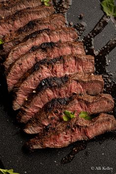 sliced steak with herbs and seasoning on the side