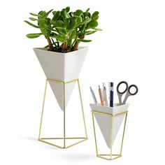 a white planter with scissors and pens in it