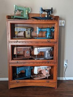 an old wooden shelf with sewing machines on it