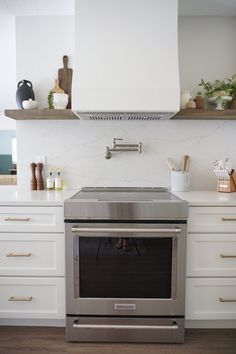 a stove top oven sitting inside of a kitchen next to white counter tops and drawers