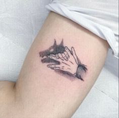 a woman's arm and hand tattoo on the left side of her leg, with black ink