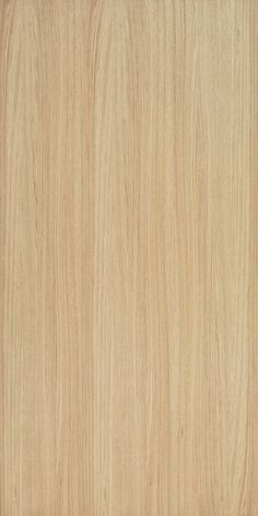 a close up view of the grained surface of a wood paneling material that is light brown