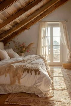 a bed sitting under a window in a bedroom next to a wooden floor and ceiling