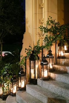 several lit up lanterns sitting on the steps