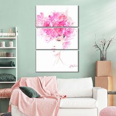 a living room filled with white furniture and pink flowers on top of the couches