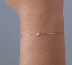 "Delicate, elegant and so classic, this 18K solid gold bracelet with bezel set solitaire diamond is the ideal gift for a lady with a birthday in April as the diamond gemstone is the birthstone for that month. She will adore you! The fine bracelet is great for layering with other bracelets and the classic styling means it can be worn every single day. Whether it's a casual lunch with friends or a formal dinner, this versatile diamond bracelet is an absolute must in any woman's jewelry collection. Daily Use Bracelet For Women, Fine Gold Bracelet, Small Diamond Bracelet, Delicate Formal Bracelet With Single Diamond, Delicate Single Diamond Bracelet For Formal Occasions, Delicate Diamond Bracelet With Single Diamond For Formal Occasions, Minimalist Hand Set Diamond Bracelet As Gift, Minimalist Hand Set Diamond Bracelet For Gift, Delicate Formal Diamond Bracelet With Single Diamond