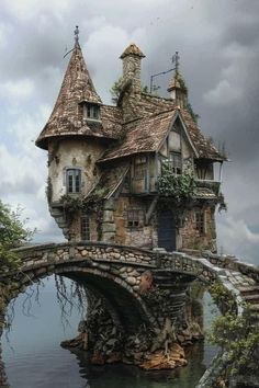 an old house with a stone bridge over water