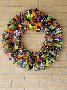 a halloween wreath hanging on a brick wall