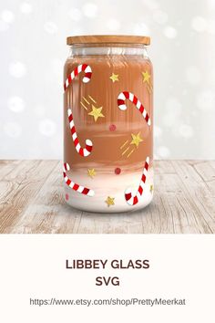 a glass jar with candy canes and stars on it