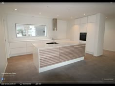 an empty kitchen with white cabinets and counter tops