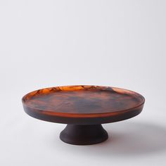 an orange and black plate sitting on top of a table