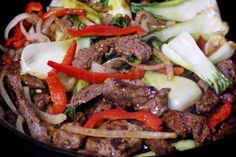 stir fry with meat and vegetables in a pan