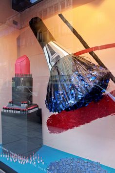 a window display with an image of a building and other items in the glass behind it