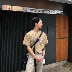 a young man standing in front of a building