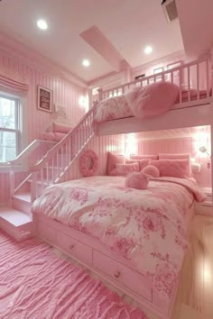 a pink bedroom with bunk beds and pillows on the bottom bed, stairs to the second floor