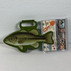 a fish shaped lunch box next to its packaging