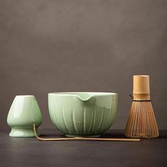 three green bowls with bamboo strainers next to each other