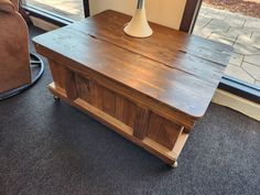 a wooden table sitting in front of a window