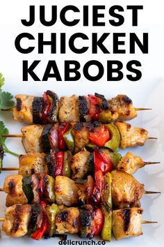 chicken kabobs on a white plate with cilantro