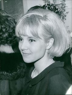 a black and white photo of a woman with blonde hair