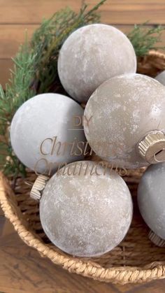 a basket filled with christmas ornaments on top of a wooden table