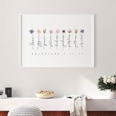 a white wall with flowers and plants on it