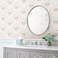 a bathroom vanity with a mirror above it and flowers in vases on the counter