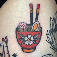 a woman's stomach with tattoos on it and an image of food in a bowl