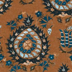 an orange background with blue and white designs on it's surface, including flowers