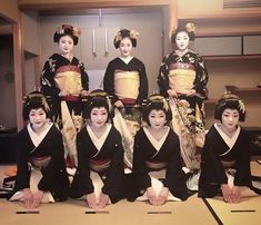 a group of women dressed in traditional geisha outfits pose for a photo together on the floor