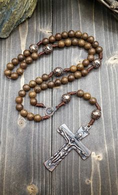 Wood Rosary Beads Necklace Catholic wooden rosary necklace with Our Father Cross and Madonna medal. Cross (H X W) : 7 cm x 3.5 cm / 2.8" x 1.4" Rosary Length: 49 cm / 19", Nazareth Store Customized Gift Velvet Bag Religious rosary of Nazareth Store makes a wonderful gift for any occasion, birthday, confirmation, First Communion, Baptism, Mother day, Christening & ideal gift for Catholic and Orthodox Christians. packed in a velvet bag to provide extra protection. Bronze Rosary With Round Beads As Gift, Bronze Rosary As Gift, Vintage Cross Necklaces With 8mm Beads, Vintage Cross Necklace With 8mm Beads, Antique Jewelry With 8mm Beads As Gift, Antique Jewelry With 8mm Beads For Gift, Antique 8mm Beads Jewelry As Gift, Bronze Spiritual Necklace With Antique Finish, Spiritual Bronze Necklace With Antique Finish