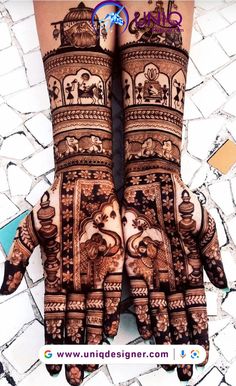 two hands with henna designs on them