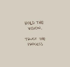 the words hold the vision, trust the process are written in brown ink on a beige background