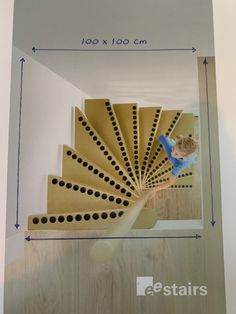 a person standing on top of a wooden stair case in front of a white wall