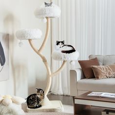 a cat sitting on top of a tree in a living room