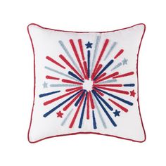 a white pillow with red, white and blue fireworks on it's side in the shape of a starburst