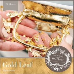 a hand holding a piece of gold leaf Amy Howard Painted Furniture, Diy Hutch Makeover, Gold Leaf Ideas, Modern Dishware, Diy Hutch, Gold Leaf Furniture, Amy Howard Paint, Leaf Ideas, St Cecilia