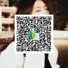 a woman is holding up a qr code to show the image on her phone