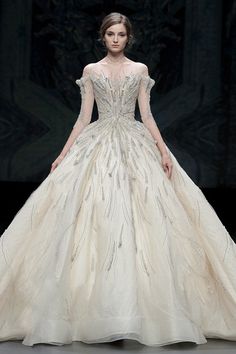 a woman in a wedding dress on the runway