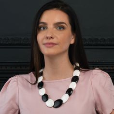 Features: * Elegant large statement necklaces for women in black and white resin. You can pair these bold necklaces with a dress, a plain T-shirt, or even with formal office wear. * 24-inch long boho necklace for women with oval resin links. Bold black and white necklace, 35 mm wide at its widest part, with a screw clasp closure. * These contemporary boho necklaces are made from black and white coloured resin. These bohemian necklaces are handmade in Rajasthan * Add a dash of colour to your outf White Resin Necklaces, Elegant White Resin Necklace, White Resin Round Necklaces, White Round Resin Necklaces, Women In Black And White, Bohemian Costume, Formal Office Wear, Bohemian Necklaces, Black And White Necklace