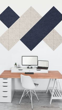 an office desk with two computers on top of it and three squares above the desk