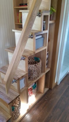 the stairs are made from wood and have baskets under them on each side to store items