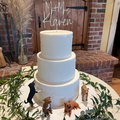 there is a wedding cake with dogs on the table next to it and a sign that says mom's heaven