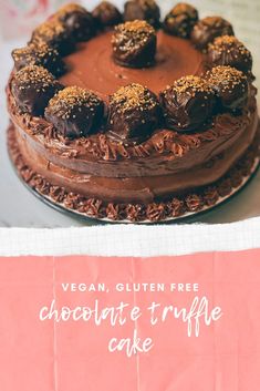 a chocolate truffle cake sitting on top of a table next to a sign