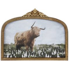 an animal with long horns standing in front of a painting on a white wall and gold frame