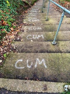 some steps with graffiti written on them and the words cum spelled in white chalk next to each other