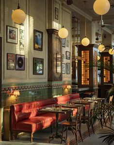 an empty restaurant with red booths and tables