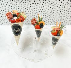 three cones filled with different types of fruit